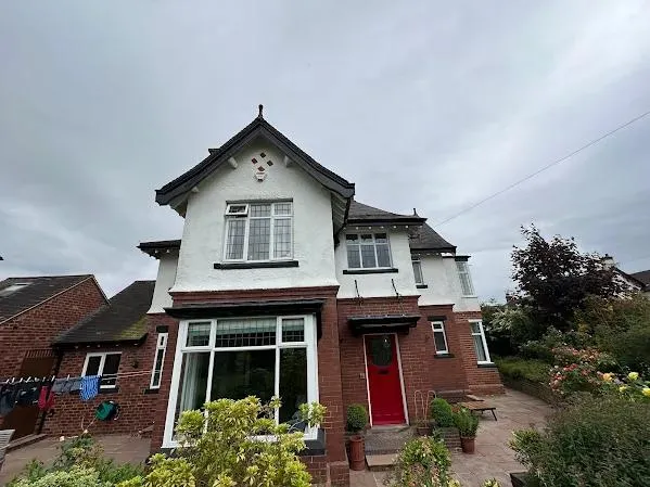 Exterior painting white render red door